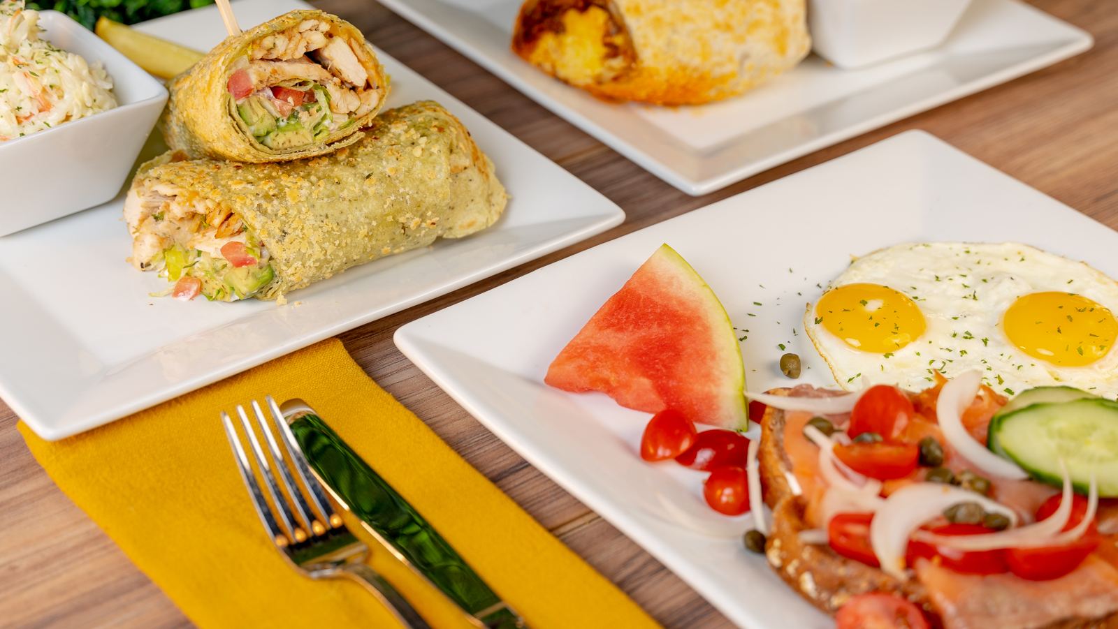 Wraps and breakfast plates spread across a table